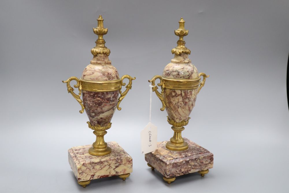 A pair of reconstituted marble and gilt metal urns, height 28.5cm